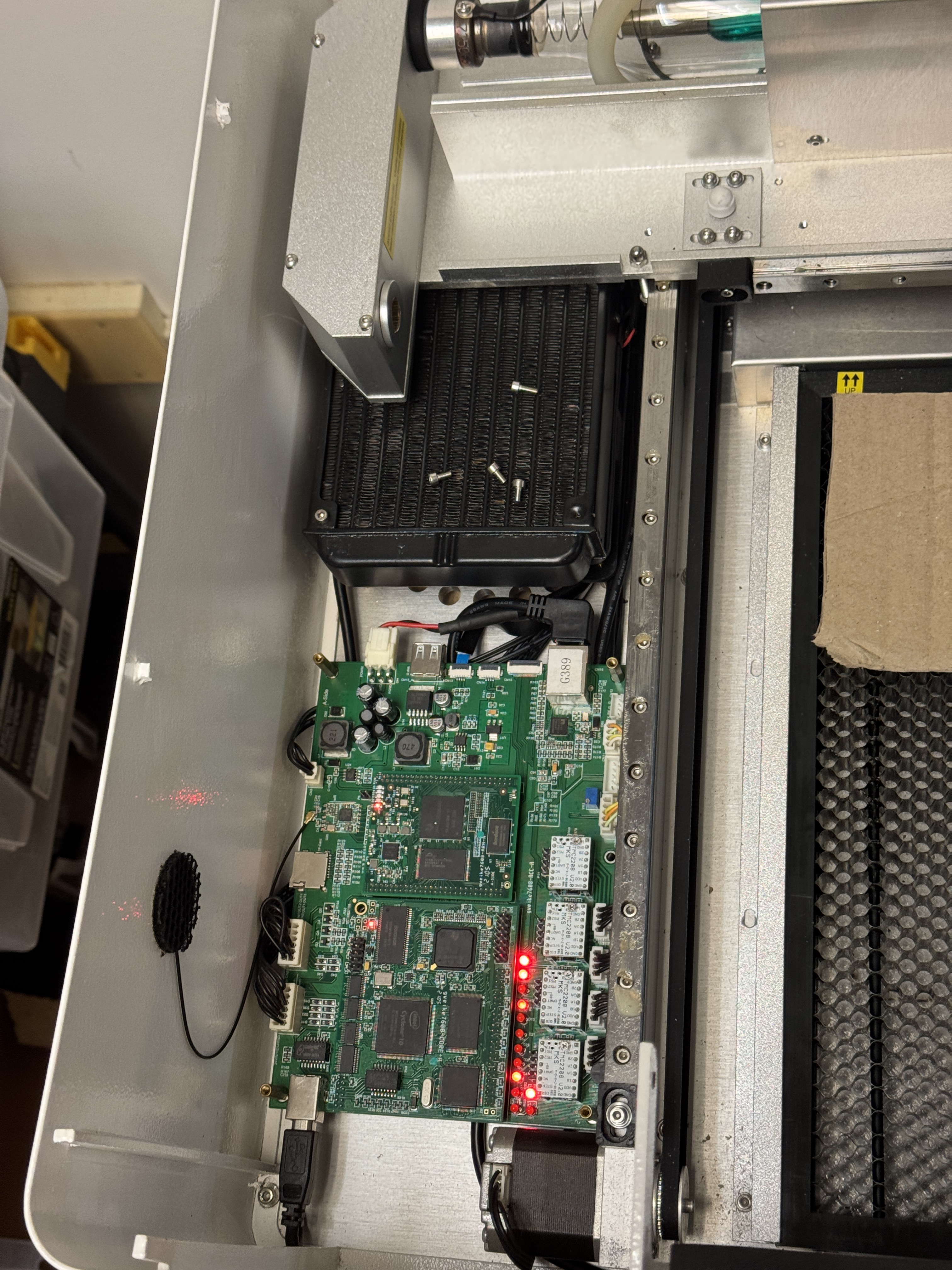 controller board with blinkenlights sitting inside of the metal housing of the gweike laser